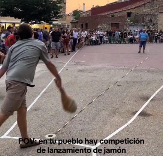 Story from Jam Press (Ham Throwing Contest) Pictured: A video grab of Spanish villagers hosting a bizarre annual content to see who can throw a ham the farthest. VIDEO: Meat your match! Spanish village hosts bizarre ham-throwing contest A Spanish village hosts a bizarre annual contest to see who can throw a ham the farthest. Footage from this year?s event shows hopefuls hurling hefty hams into a marked area reminiscent of a hammer throw landing sector. The quirky competition takes place every August in Carrascosa de la Sierra. Nestled in Spain?s Soria province, the village is home to just 70 year-round residents ? but the population balloons to over 400 during the festivities. Known as the Campeonato de Lanzamiento de Pernil - Ham Throwing Championship - the tradition began decades ago as a joke among friends at the local bar. This year, it went viral thanks to 24-year-old Tal?a Benedicto, who has roots in the village and shared a montage of the event on social media. The thrown ham isn?t wasted ? it?s wrapped in tape and bubble wrap before being launched and serves as a trophy for whoever throws it the farthest. Tradition dictates, however, that the winner shares it with locals and visitors alike. This year?s men?s champion was Sergio Garc?a, whose throw reached 20.55 metres, as reported by What's The Jam. There are also categories for women, who throw shoulder hams; children, who launch salchich?n; and even toddlers, who toss mini fuet. What began in 1997 as a quirky idea to liven up the August festivities has become the village?s defining symbol. ?The locals are really excited because we?ve put Carrascosa on the map,? Tal?a told local media. Carrascosa isn?t alone in Spain?s oddball festival scene. In Carcabuey, C?rdoba province, there?s an olive-pit spitting championship. In the Galicia region, turnip tops fly through the air in a dedicated contest. The Navarra region hosts espadrille-flinging events. And in the Castile and Le?n region, contestants toss hoes in pursuit of glory. ENDS EDITOR?S NOTE: Quotations have been translated to English. We would advise obscuring the faces of the children in the crowd shown in the video prior to publication. Grabs have been provided with blurring for your reference. Video Usage Licence: (NON-EXCLUSIVE) We have obtained a non-exclusive licence from the copyright holder. A copy of the licence is available on request. Video Restrictions: None.