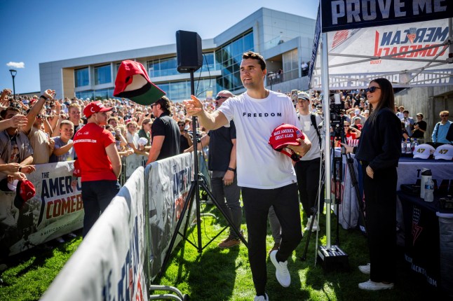 15088909 Elon Musk unleashes explosive rant on Kirk assassination calling the left 'the party of murder' Charlie Kirk hands out hats before speaking at Utah Valley University in Orem, Utah, Wednesday, Sept. 10, 2025. (Tess Crowley/The Deseret News via AP)