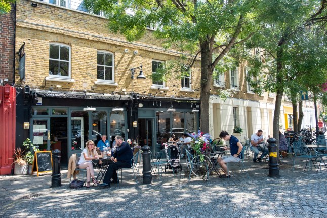 LONDON- JULY, 2019: People sitting outside a cafe in Battersea Square in Wandsworth, south west London; Shutterstock ID 1461740738; purchase_order: -; job: -; client: -; other: