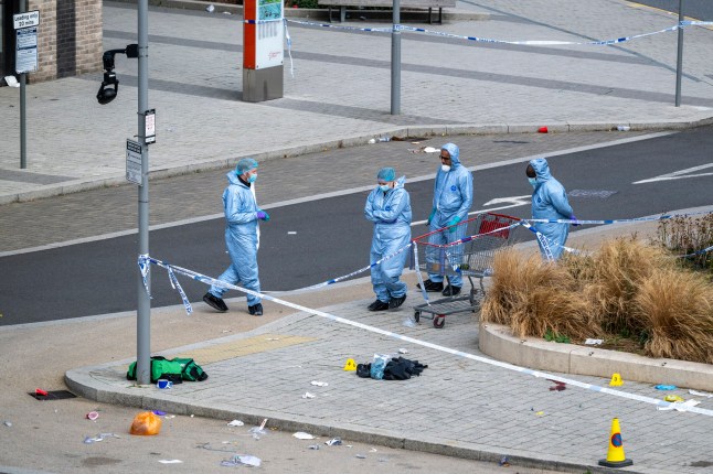 ?? Licensed to London News Pictures. 21/09/2025. LONDON, UK. Forensics officers at work at a crime scene near Wembley Stadium following a reported shooting in Atlantic Crescent after police and ambulance service were called at 5.30am. A discarded green first aid kit, a pile of clothes and a pair of shoes are seen next to an evidence marker. A patient has been taken to a major trauma centre and nearby roads, including South Way, are closed as enquiries continue. Photo credit: Stephen Chung/LNP