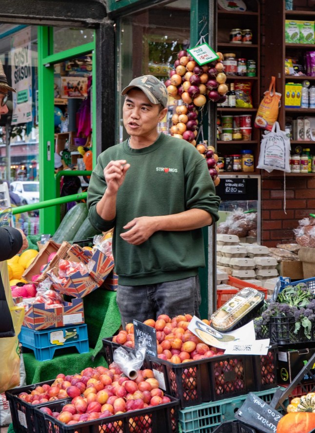 Store assistant Wai Peng Cheng, 51, An engineer sent to probe a suspected gas leak at a greengrocers was shocked to discover the cause was the world's smelliest fruit. Staff at Strongs Fruit and Veg shop were bemused when a Cadent gas engineer walked in to try and identify the source of the leak. Photo released 22/09/2025