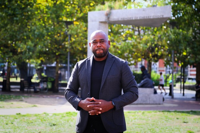 Son of Cherry Groce, Lee Lawrence, poses for a photograph in front of the Cherry Groce Memorial Pavilion in Windrush Square, Brixton.