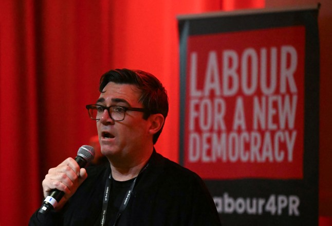 Greater Manchester mayor Andy Burnham speaking into a microphone at the Labour Party conference.